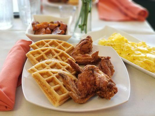 Crunchy chicken and waffles with a side of eggs and yams