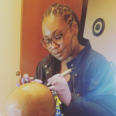 Me applying Scalp Micropigmentation (SMP) to client scalp.