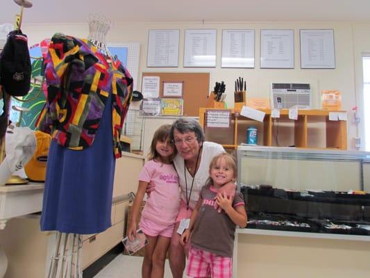 Shoppers at thrift store with Debbie, a long time volunteer there.