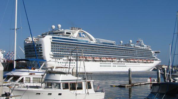 The ship is passing Ports O'Call Village. Passenger ships are no longer sleek and yacht like. They are now floating condominium blocks.